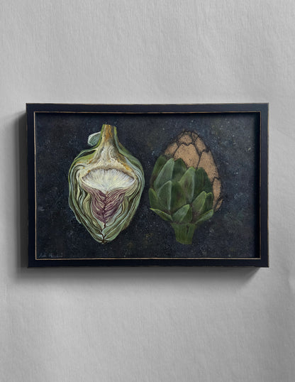 Framed artwork of two artichokes on a dark background. By Adi Radai
