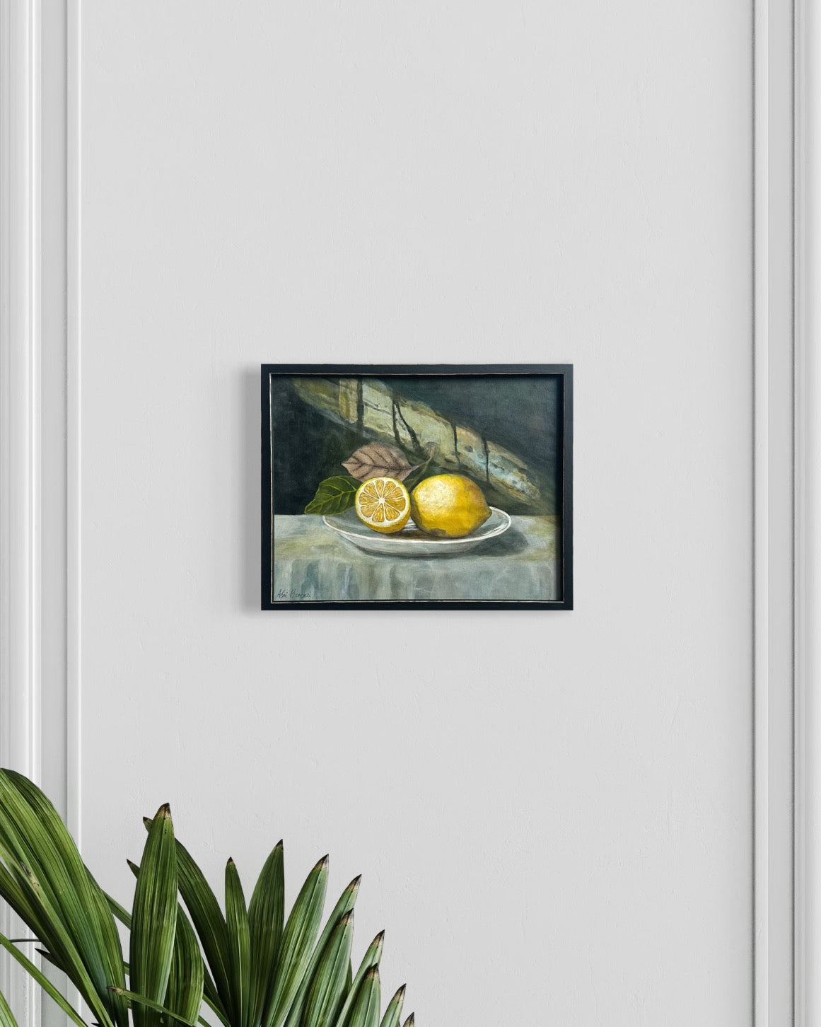 Framed still life painting of lemons on a plate. By Adi Radai