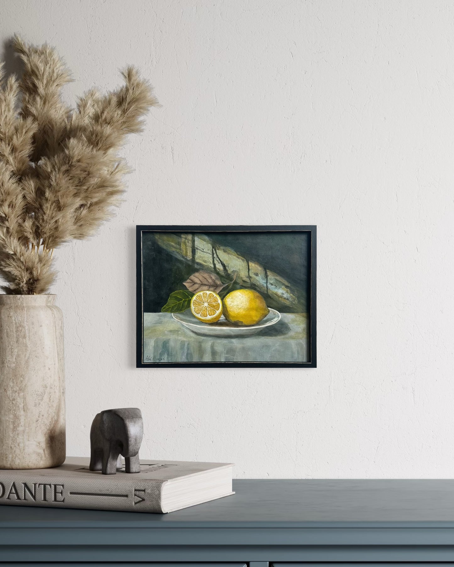 Framed still life painting of lemons on a plate. By Adi Radai
