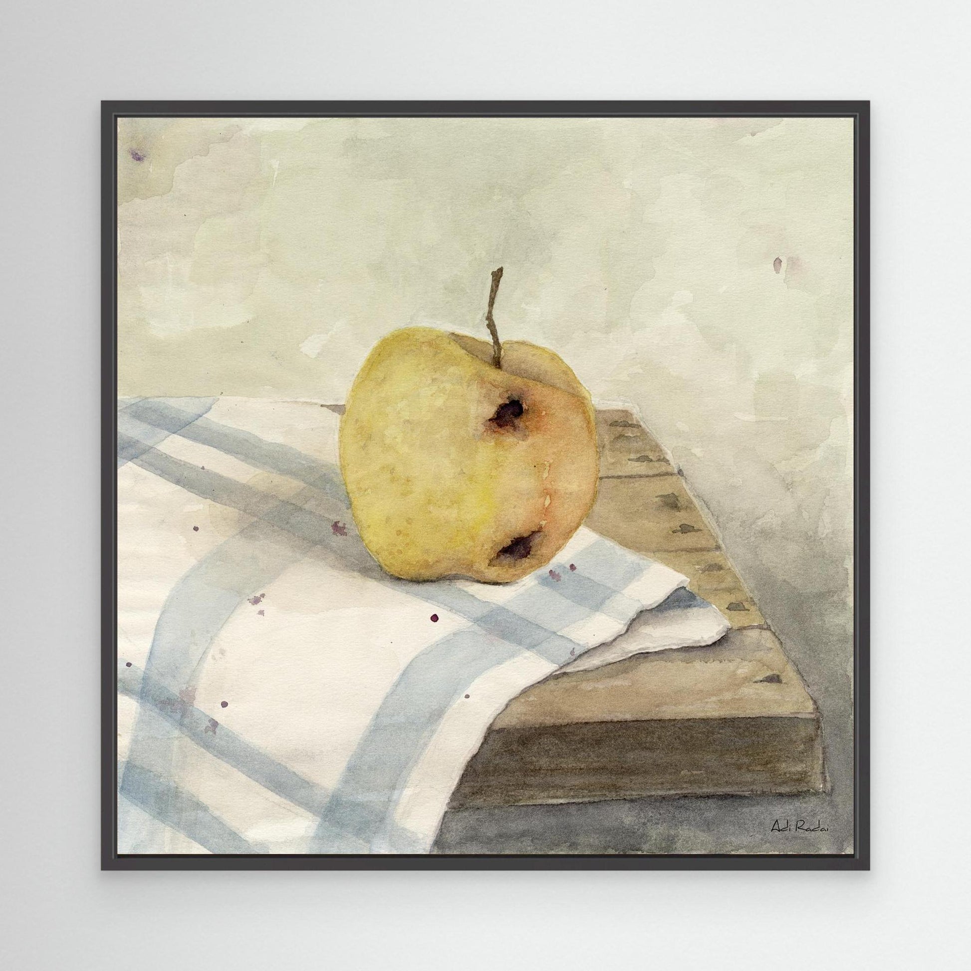 Framed art print of an apple on a table map, still life. By Adi Radai